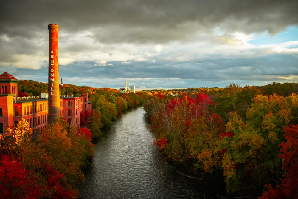 Fall colors and foliage view of the Blackstone River during the best time to visit Rhode Island
