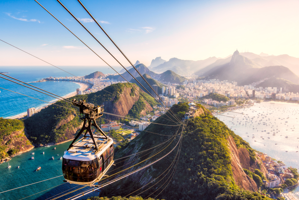 Cable car seen from the top of Sugar Loaf Mountain overlooking the city pictured during the cheapest time to go to Rio de Janeiro