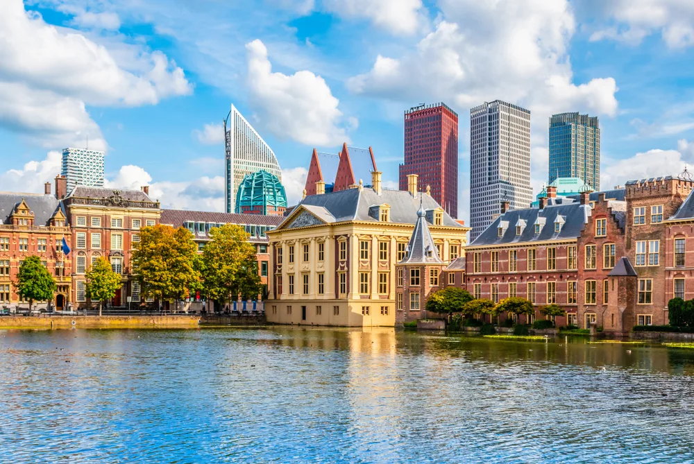 The Hague skyline against a blue sky with white clouds as seen from across the lake during the best time to go to the Netherlands