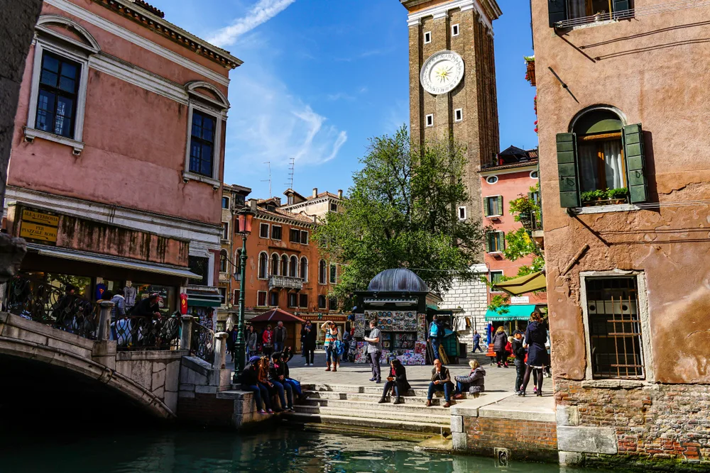 Image of a town square in San Polo, one of the best places to stay in Venice, pictured in the summer