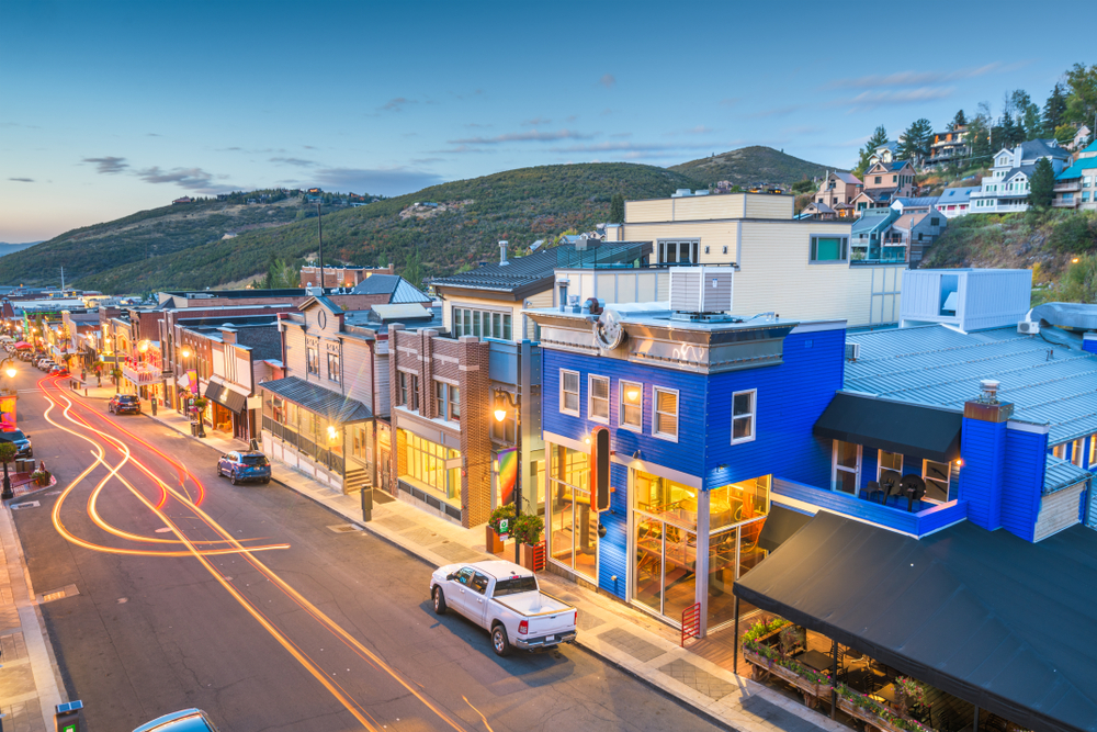 Aerial view of a town street at twilight for a frequently asked questions section on the best time to visit Park City Utah
