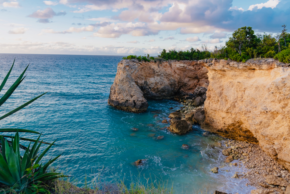 View of rocky cliffs and the ocean during the least busy time to visit Anguilla when tourism drops