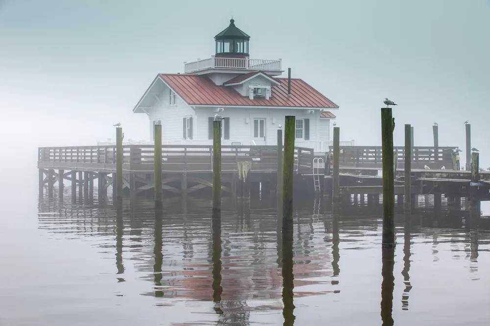 Misty scene around the lighthouse in Shallowbag Bay in downtown Manteo during the least busy time to visit the Outer Banks
