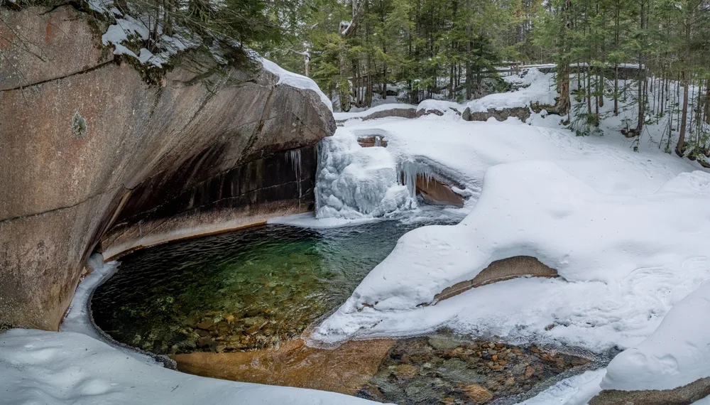 View of The Basin in Franconia Notch State Park during winter, the cheapest time to visit New Hampshire