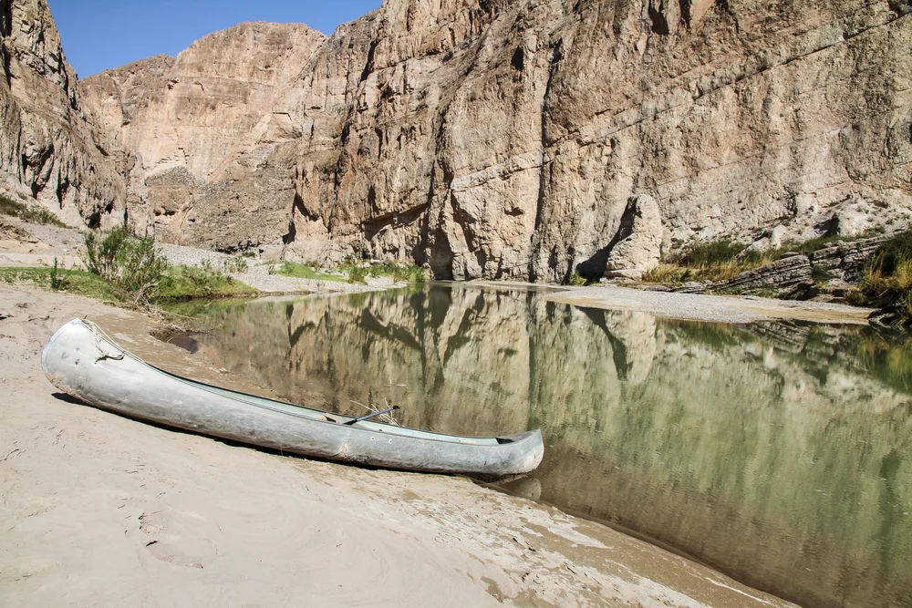 Canoe on the side of a river in Big Bend National Park in the summer, the worst time to visit