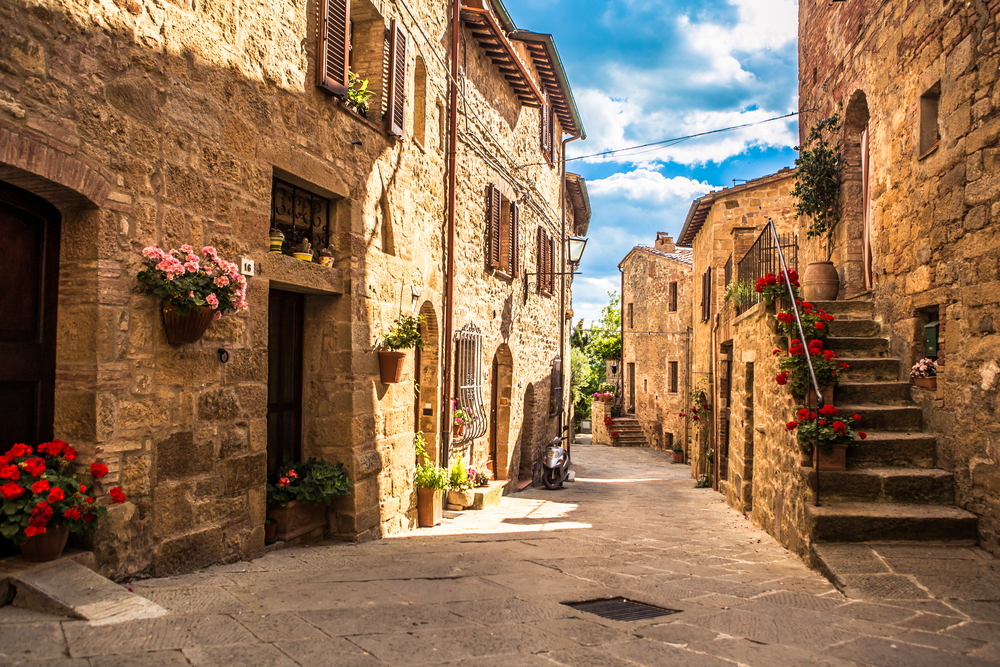 Streets of an old Italian city, Tuscany, pictured during the least busy time to visit while walking through a narrow brick alleyway