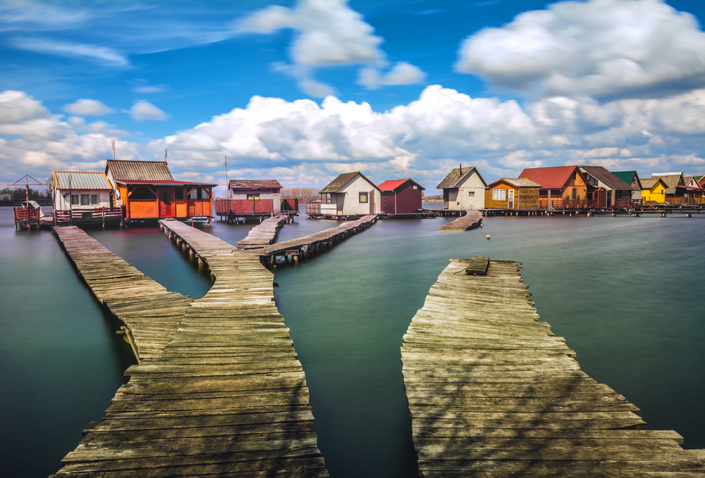 Fishing village with cottages and floating docks on Bokod Lake for a piece on Is Hungary Safe