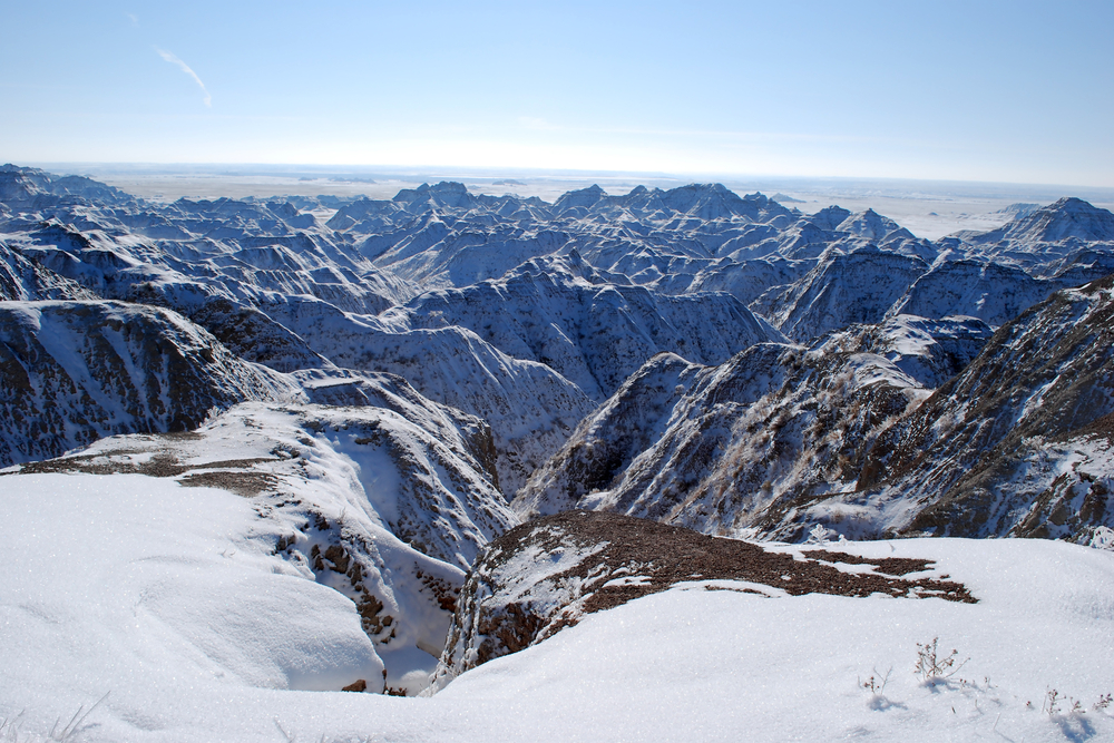 Park shown draped in winter snow during the worst time to visit Badlands National Park