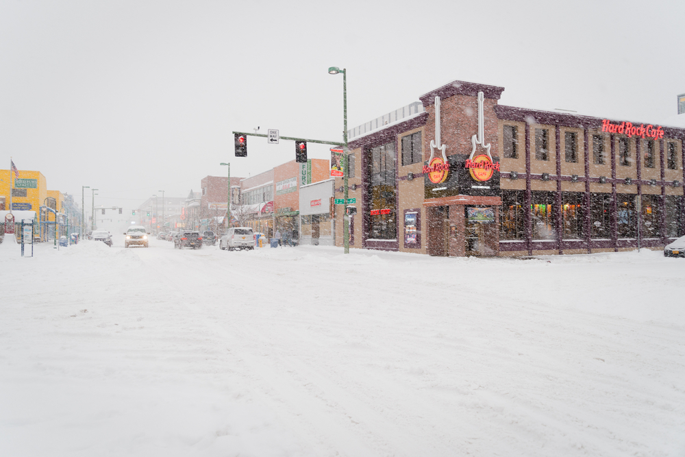 Heavy snowfall on a corner of the street in Anchorage during the worst time to visit