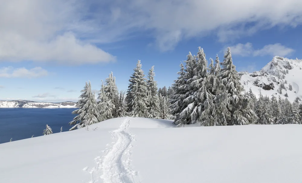 View of a single person's footprints on the snow pictured during the least busy time to visit Crater Lake
