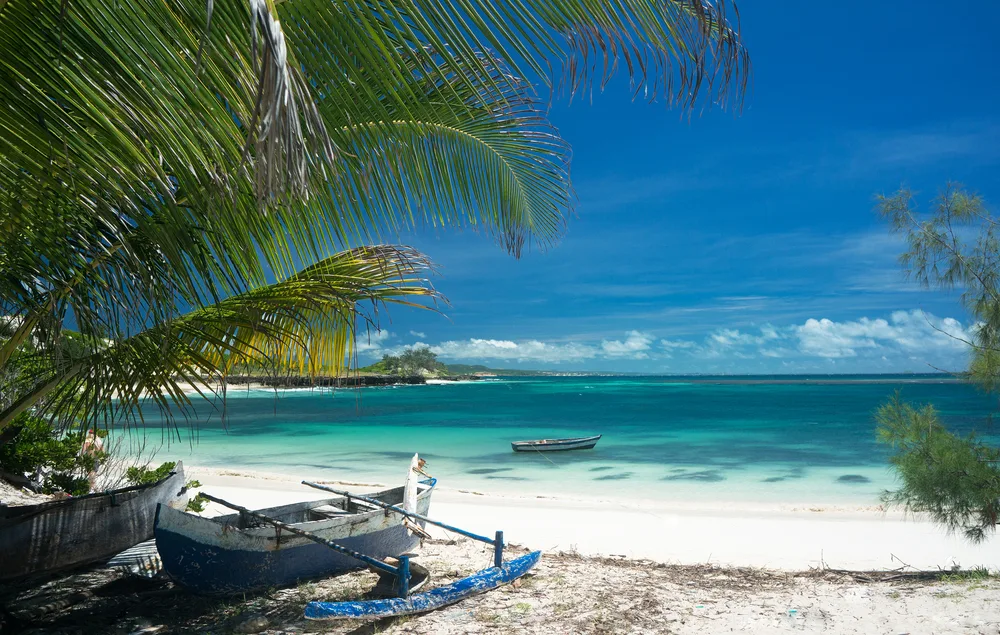 Crystal-clear teal water and white sand beach pictured during the best time to visit Madagascar
