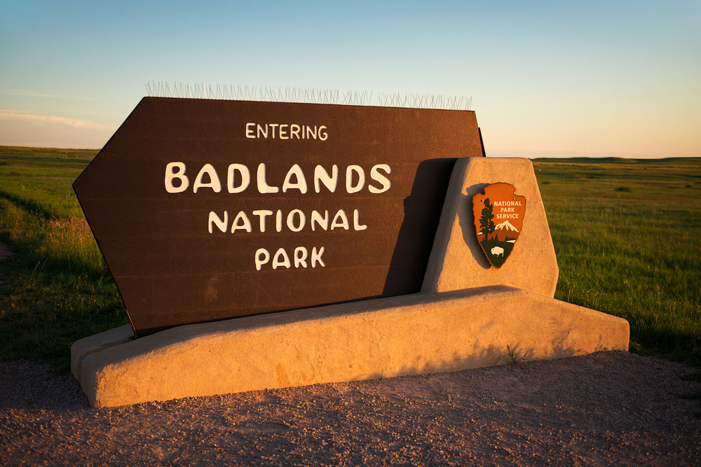Sign greeting visitors to the park for a frequently asked questions section on the best time to visit Badlands National Park