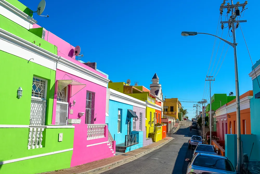 Extremely bright neon homes line an empty street in Bo-Kaap during the least busy time to visit Cape Town