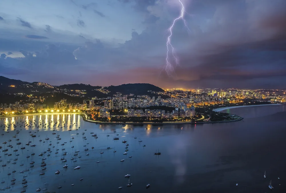 Image of a storm over the bay and the city during the worst time to visit Rio de Janeiro
