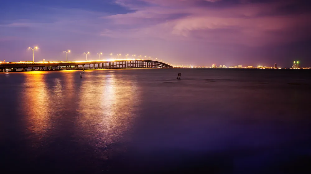Queen Isabella Causeway leading to the island at sunset shows the cheapest time to visit South Padre Island, Texas