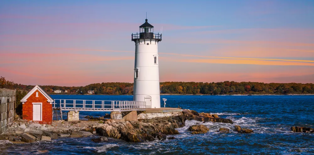 Portsmouth Harbor Lighthouse at sunset shown during the worst time to visit New Hampshire