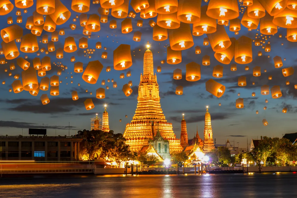 Amazing view of hundreds of paper lanterns lit and floating above the temple and street during the Yee Peng Festival