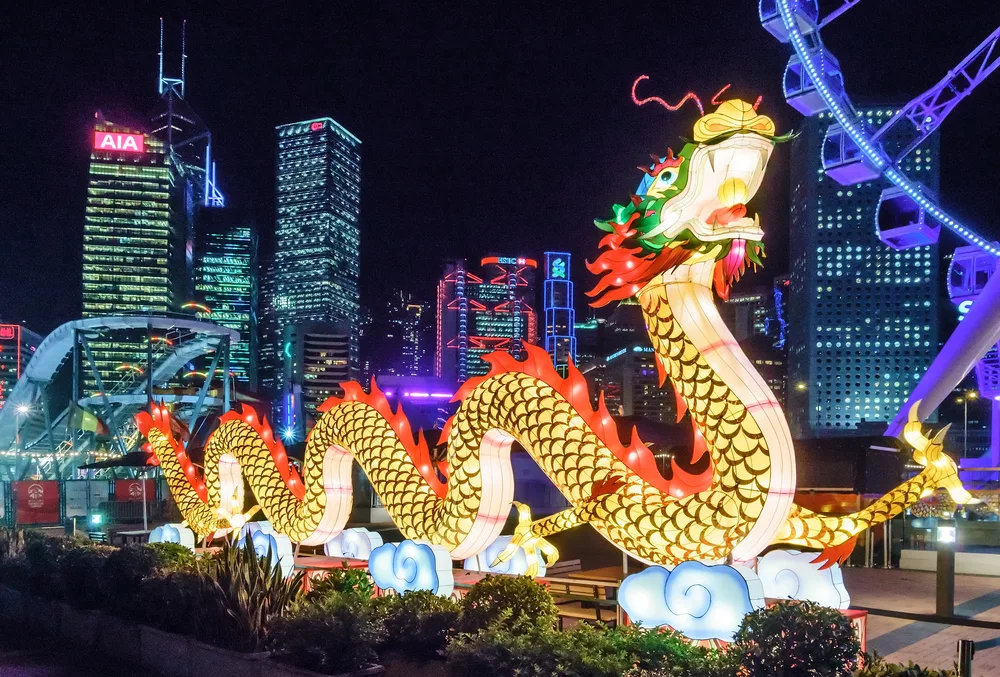 Unique festival featuring a giant inflatable Chinese dragon with the buildings of downtown in the background during the best time to visit Hong Kong