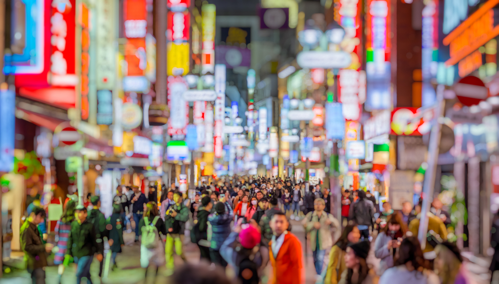 Bokeh view of Shibuya Shopping Street in the city with lots of people walking for a piece on Is Tokyo Safe