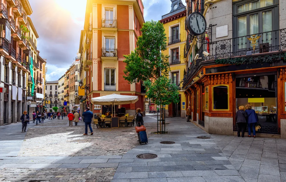People mulling about in the cozy Old Town part of Madrid during the best overall time to visit