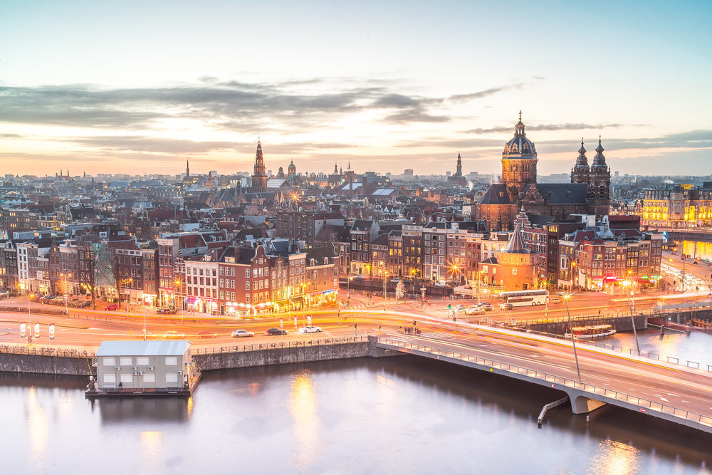 Aerial view of the city at sunset showing the skyline for a piece on Is Amsterdam Safe