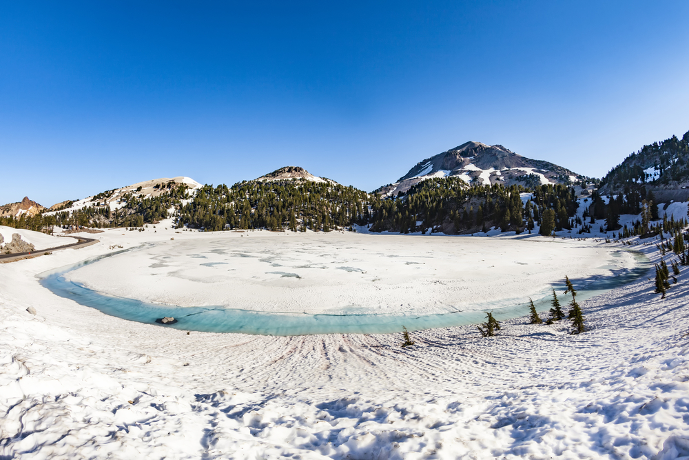 Image of a snow covered crater pictured during the cheapest time to visit Lassen Volcanic National Park, the winter
