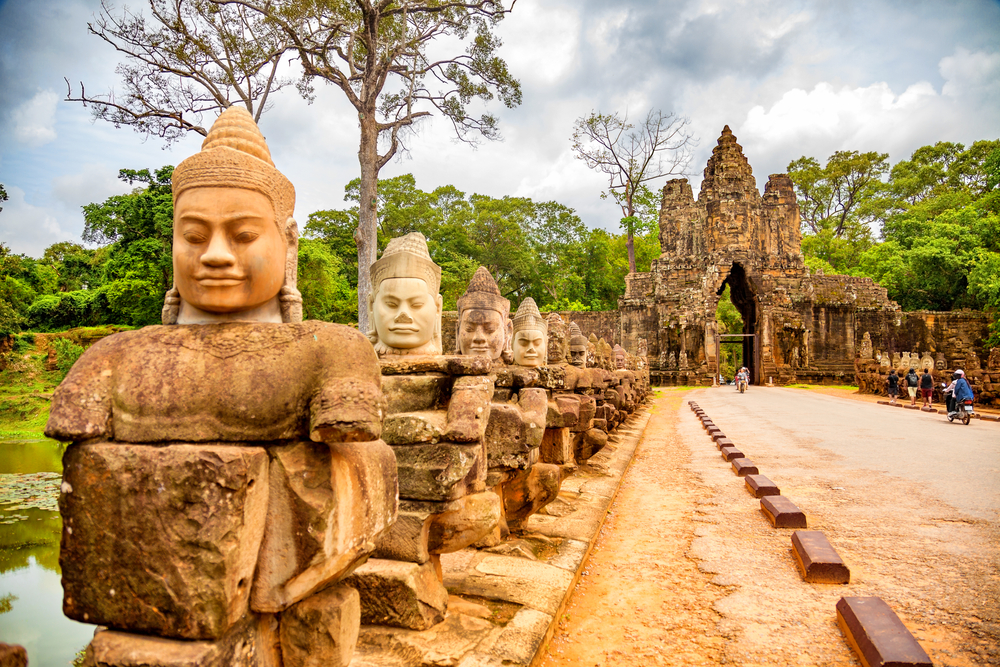Row of sculptures lining the path to the Gate of Angkor Thom during the least busy time to visit Cambodia