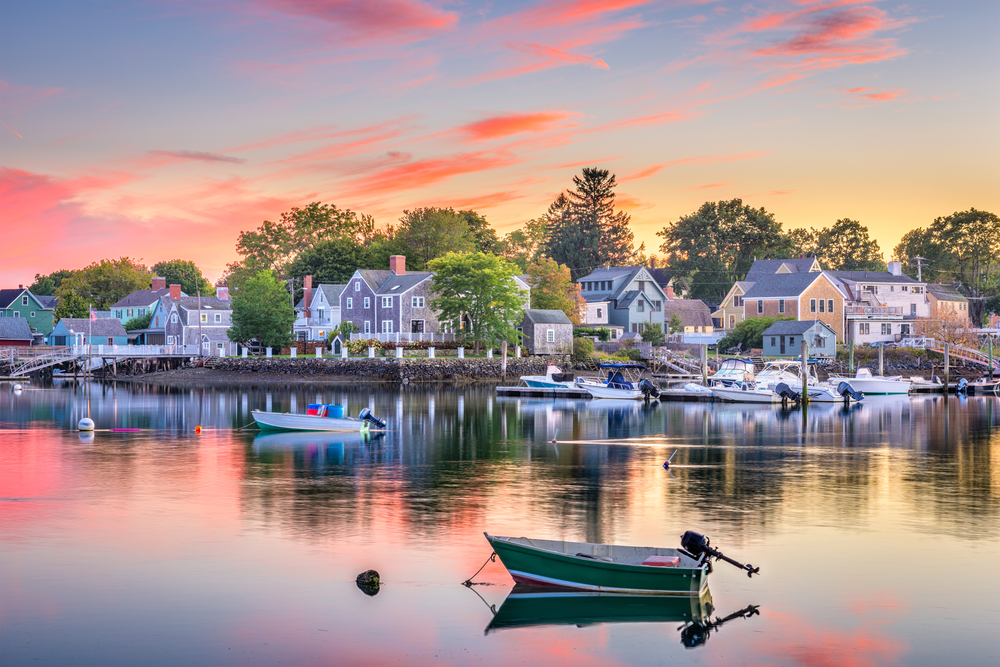 Sunset view of Portsmouth harbor with boats in calm water showing why you should visit New Hampshire