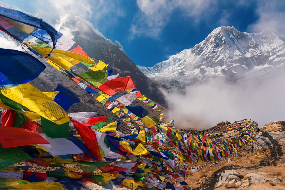 Amazing view of colorful flags pictured over Mt. Annapurna in the background, as seen from the Annapurna Base Camp