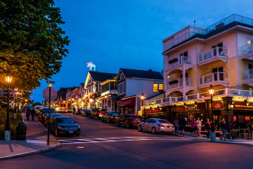 People walking downtown at night during the least busy time to visit Bar Harbor Maine
