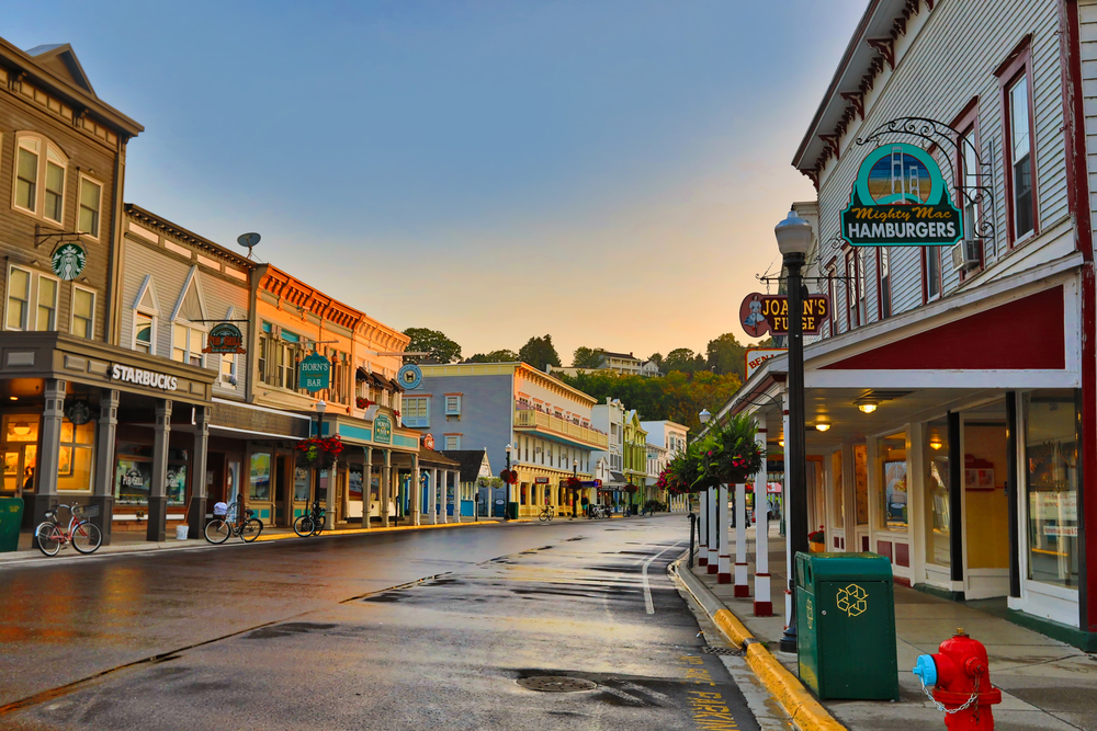 Empty streets of the downtown area with cold weather and wet streets pictured at dusk during the least busy time to visit Mackinac Island