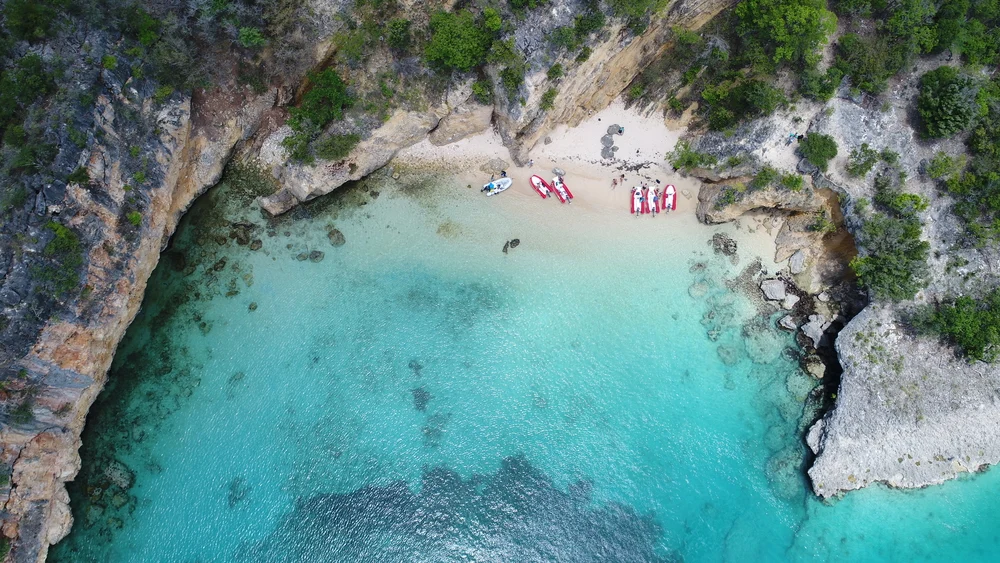 Little Bay shown from above on a beautiful day with calm water to indicate why you should visit Anguilla