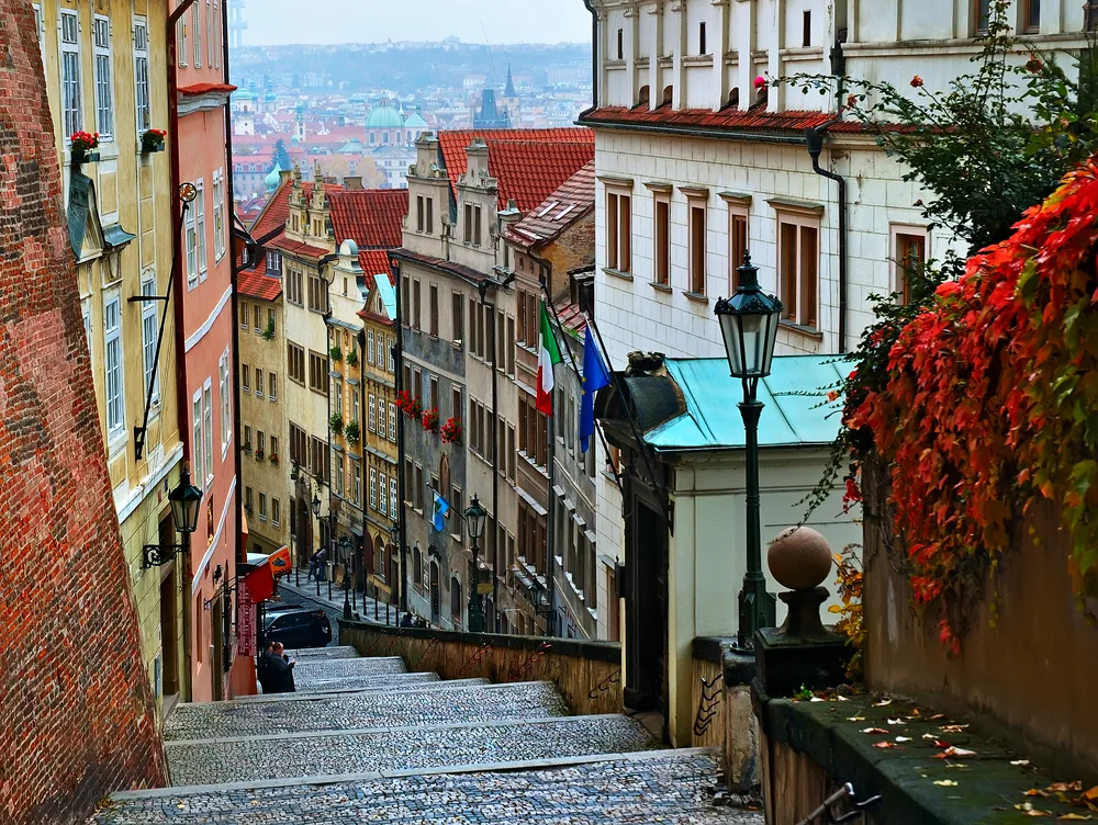 POV of a person walking down the stairs of Old Town Prague during the best time to go