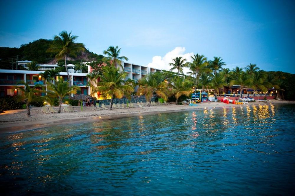 Bolongo Bay Beach Resort, one of the best resorts in the Virgin Islands, pictured from a boat on the ocean looking toward the oceanfront rooms