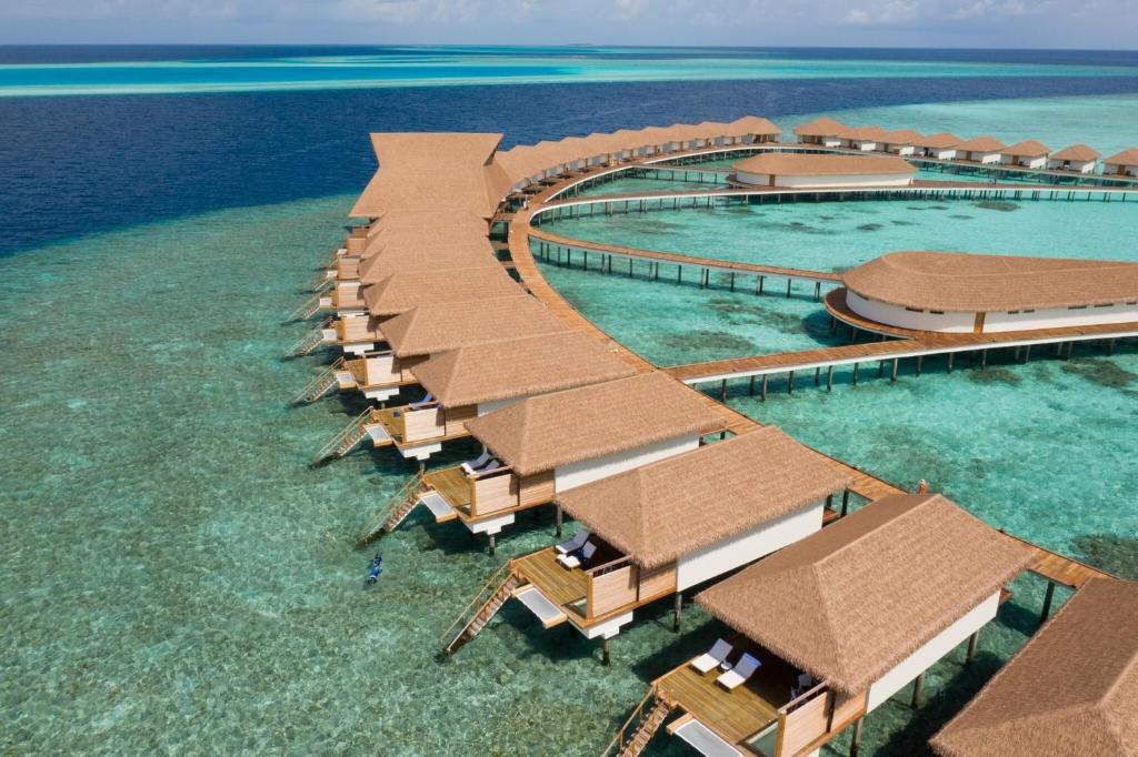 Bungalows at Cinnamon Velifushi, one of the best resorts in the Maldives, with a boardwalk connecting them all