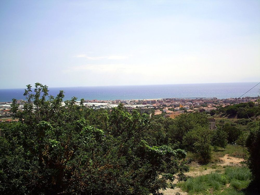 Premià de Mar, one of the best day trips from Barcelona, pictured overlooking the ocean from the top of a hill