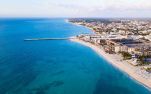 Pictured during the best time to visit Playa del Carmen, the long expansive beach is shown with blue water