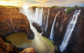 Beautiful afternoon image of Victoria Falls with Golden skies above these giant falls
