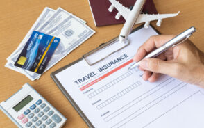 Concept representing how much does travel insurance cost with calculator, insurance form, money, credit card, and plane model on a desk