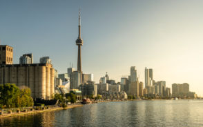 Gorgeous skyline of Toronto pictured during the best time to visit with the sun setting over the water