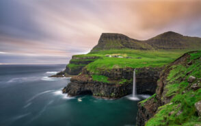 Photo of Gasadalur village and its gorgeous waterfall pictured during the best time to visit Faroe Islands