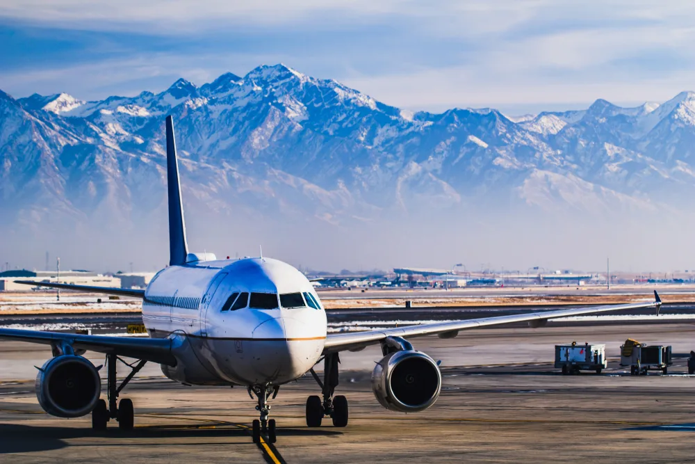 Cool mountains in the background of an airport during the best time to visit Salt Lake City, the winter