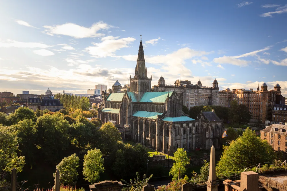 Glasgow Cathedral pictured from the air with an impressive-looking structure overlooking the green trees in the park