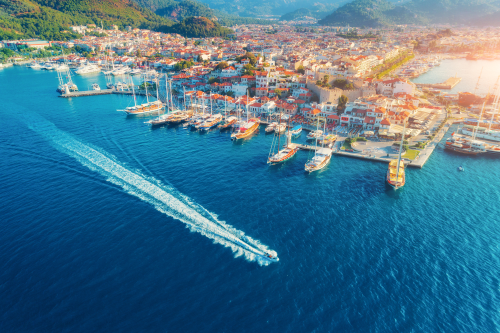 Aerial view of a boat driving on the water in front of the marina at Marmaris for a piece on the best places to visit in Turkey