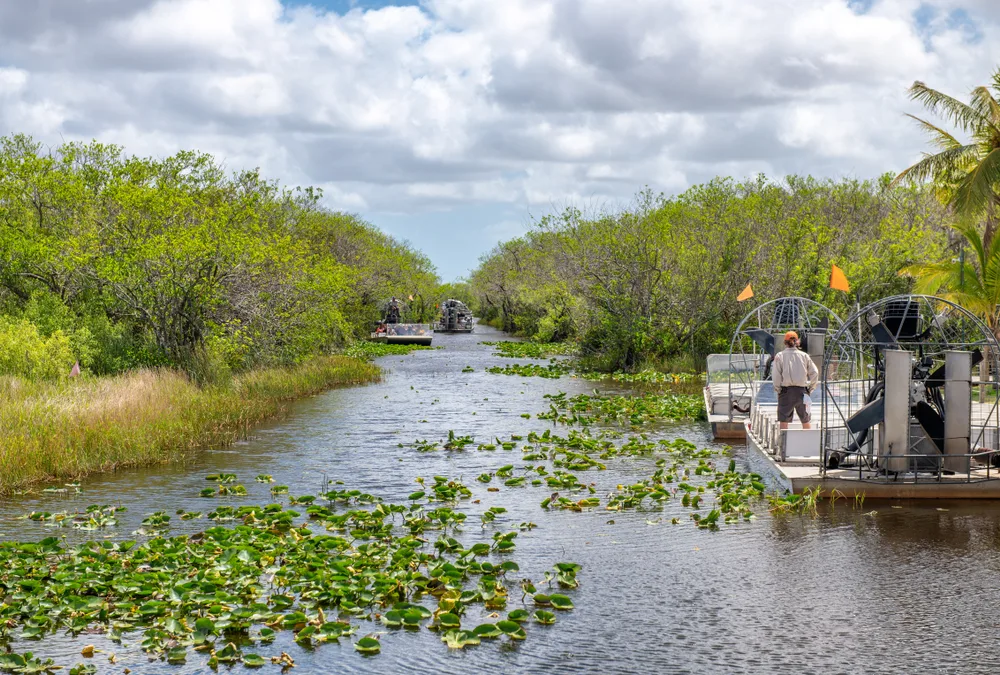 Multiple people on airboats in the Everglades, one of the best places to visit in the South