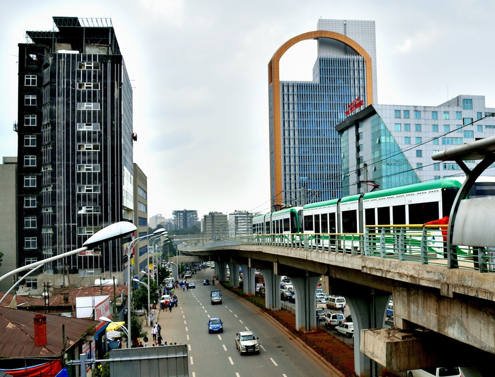 Photo of the downtown area in Addis Abada pictured with towers on either side of the elevated train