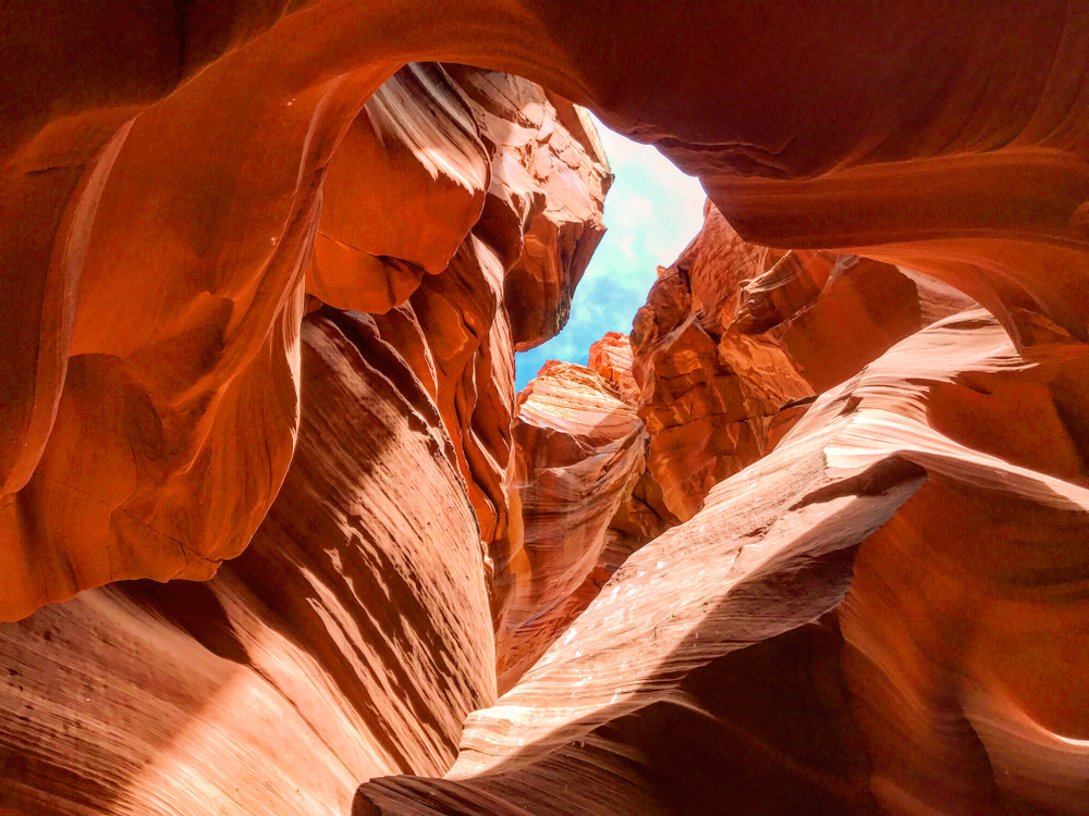 Slot Canyon in Page, Arizona, pictured with sun beaming in from the rim during the best time to visit Horseshoe Bend