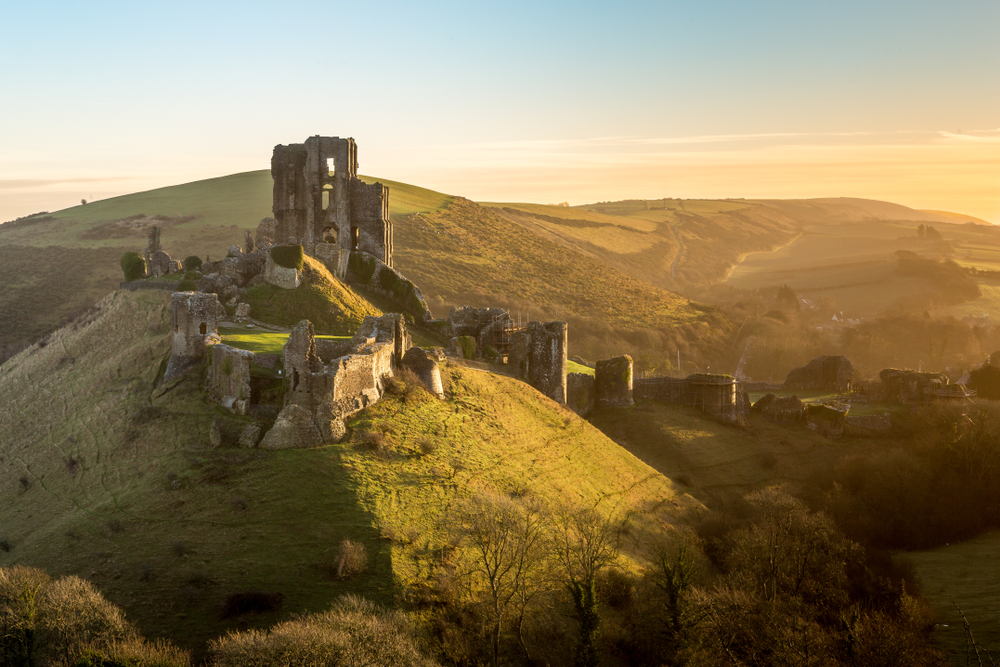 Amazing dusk view of the hilltop ruins of Corfe Castle, one of the best places to visit in England