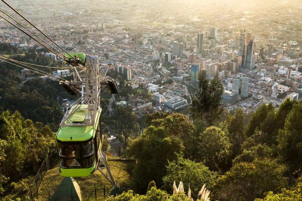 Green cable car pictured going up the mountain at sunrise in Bogota, one of the best places to visit in South America
