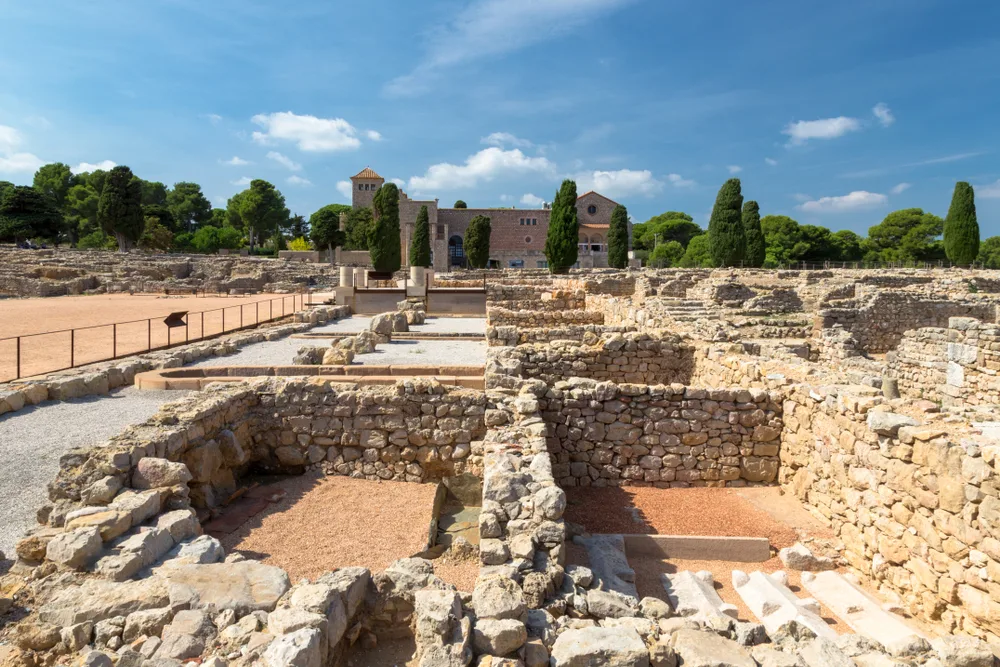 Pictured in teh Gulf of Roses in Catalonia are the ruins of Empuries, one of our favorite day trips from Barcelona